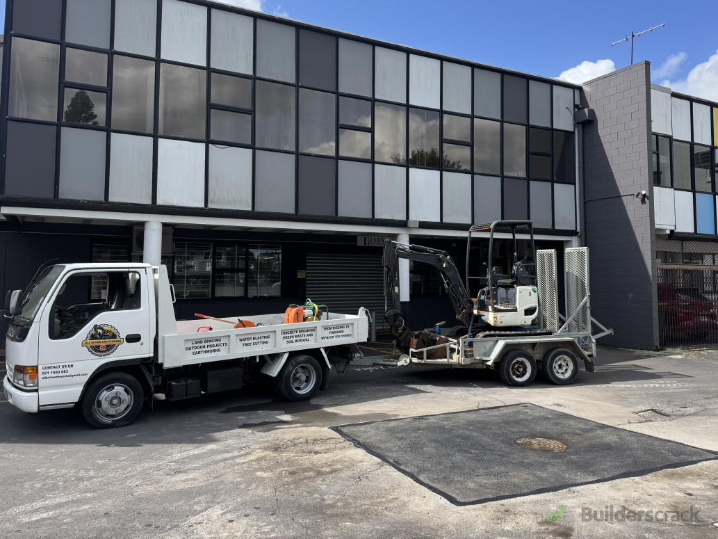 Earthworks truck and machinery at a completed asphalt area