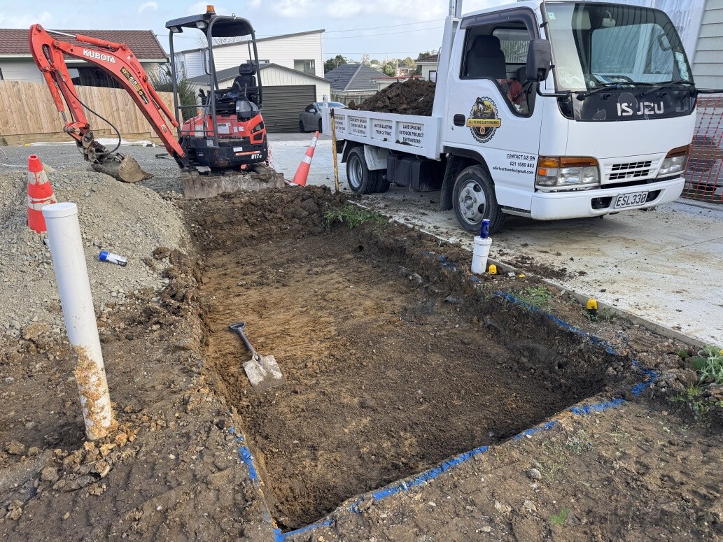 Excavator and tip truck working on a residential site